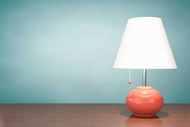 A cozy and inviting bookshelf that features a lamp shades