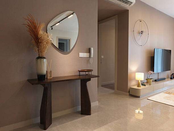 Elegant hallway corner featuring a dark wood console table,Fabric lamp shades