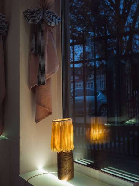 The soft, warm glow of a bedside lamp shades casting a cozy light.