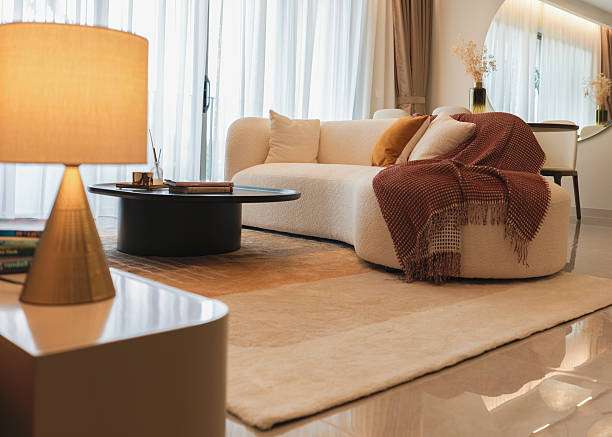Warm living room with textured sofa and cone lamp shades.