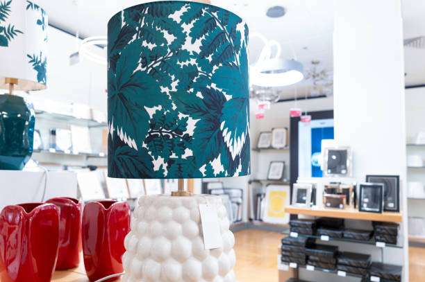 Decorative blue floral lamp shades in a home decor store display.