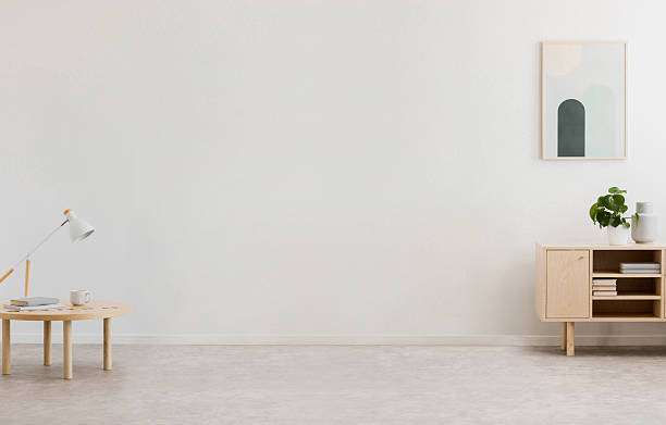 Minimalist room with a small white lamp, simple lamp shades, and modern wooden furniture.