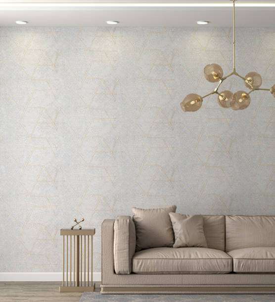 Modern living room with sofa, textured wall, and abstract chandelier lamp shades.