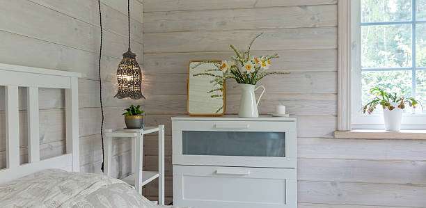 Ornate pendant lamp shades hanging above a bedside table.