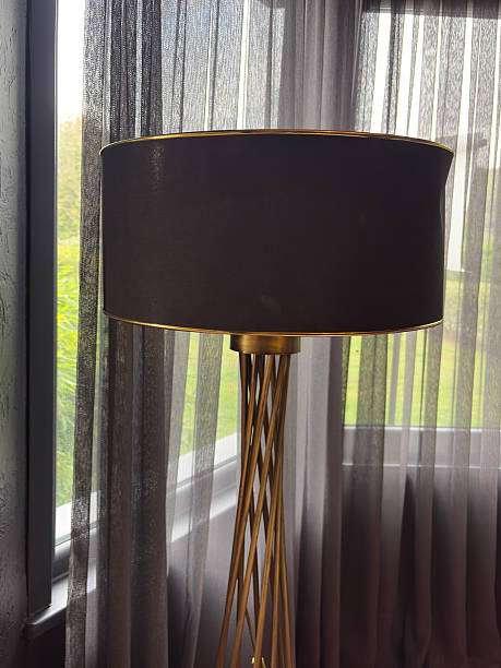Elegant black drum lamp shade with a decorative gold trim.